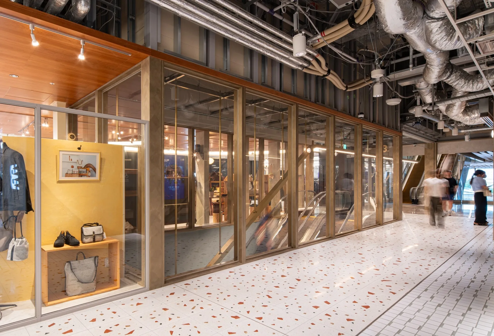 Heat-resistant laminated glass transparently partitions the space, maintaining visual continuity.
